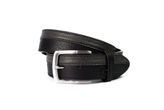 A close-up of a black leather belt with a silver buckle, designed in Italy. Sporty style and preppy design. Adjustable size. Ideal for gifting.