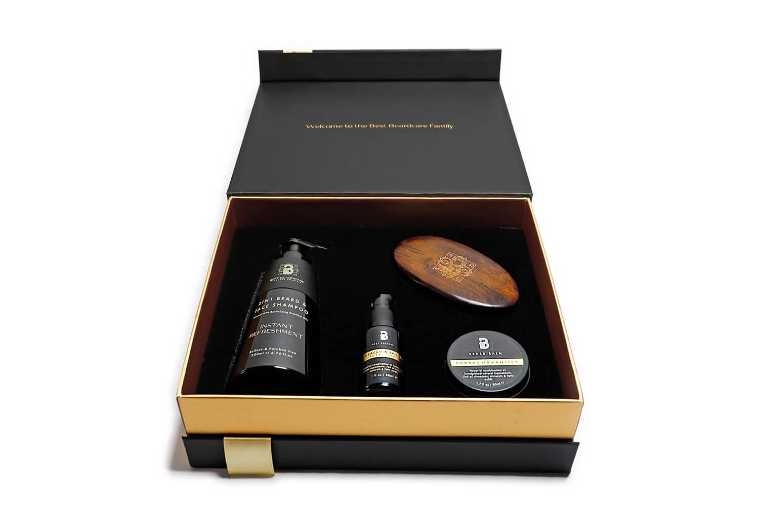 Tobacco & Vanilla Gift Set Beard Grooming Kit with box, shampoo, lotion, and wooden oval logo object. Includes beard oil, wax, and brush.