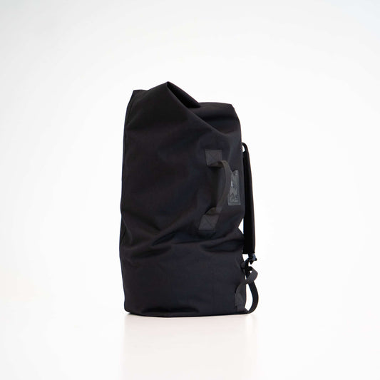 Duffle Bag - Black: A versatile black bag with shoulder straps and a handle for carrying options. Made from durable polyester, it offers ample room for essentials.