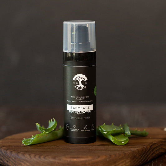 Aftershave balm bottle with hyaluronic acid, oat protein, coconut water, aloe, and allantoin for soothing and moisturizing skin after shaving.
