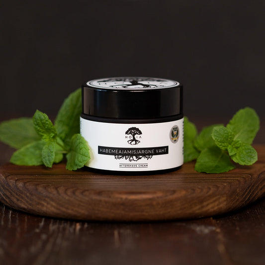 A jar of peppermint aftershave foam on a wooden surface, perfect for nourishing and moisturizing skin.