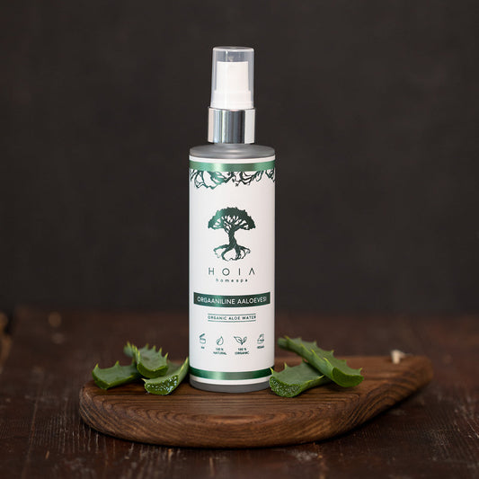 A bottle of Organic Aloe Water, rich in minerals and antioxidants. Hydrates, softens, and refreshes skin and hair. Suitable for all skin types.