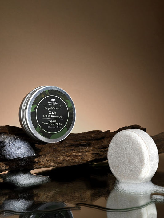 A round container of Solid Oak Shampoo 'Imperial' for men, featuring a green label and a white round object with bubbles.