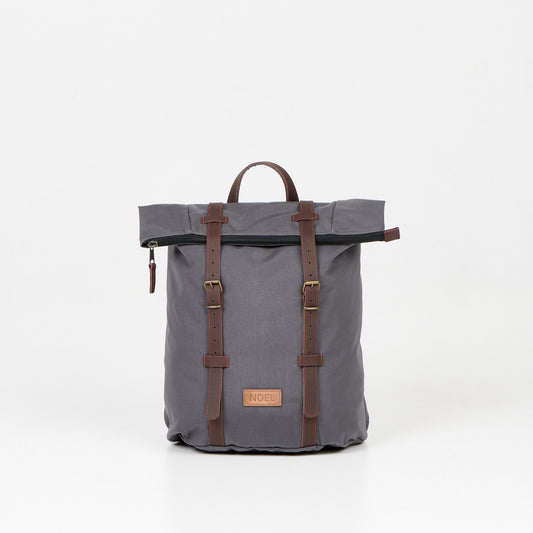 A 12L Waterproof Backpack - Dark Grey with brown leather straps, perfect for urban adventures and daily commutes. Spacious, durable, and handcrafted in Europe.