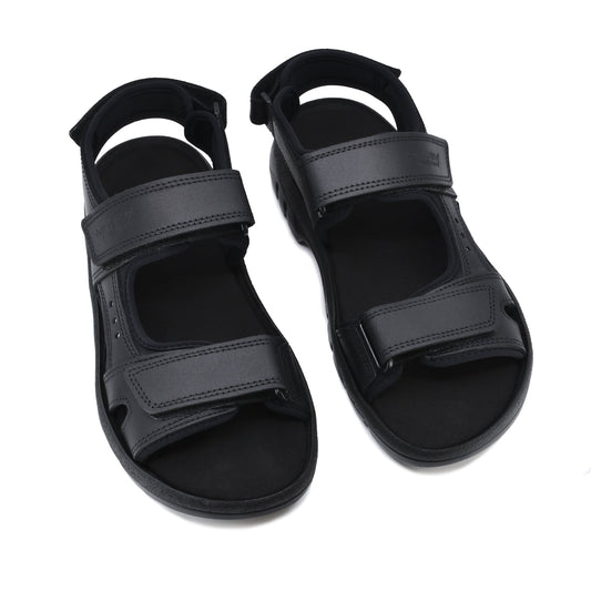 A pair of black leather sandals with adjustable velcro straps, perfect for hiking. Crafted from natural leather, these sporty sandals offer durability, breathability, and a comfortable fit. European craftsmanship ensures superior quality.