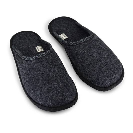 A pair of black Natural Felt Slippers, crafted in Europe from sustainable materials. Slip-on style for convenience. Durable rubber outsole.