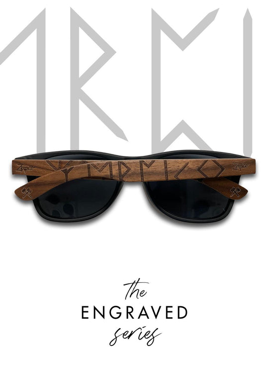 A pair of Eyewood engraved wooden sunglasses with Viking Runes scripture on the temples. Handmade with polarized black lenses and high-quality stainless steel hinges.