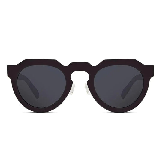 A close-up of ReVision Round - Eco-Friendly Recyclable Paper Sunglasses, a black pair of round sunglasses with grey lenses.