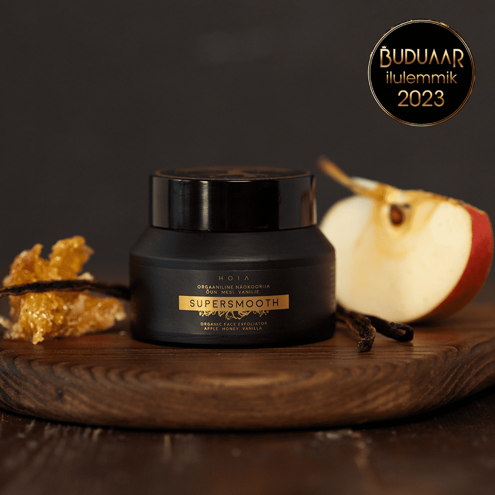 A jar of Organic Face Scrub with apple water and olive stone powder for gentle exfoliation and deep moisturization.