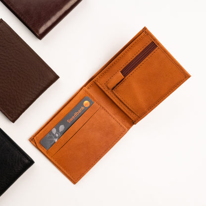 A sleek leather wallet with a card and coin zipper. Thoughtfully designed to hold essentials without bulk. High-quality craftsmanship from Men In Style.