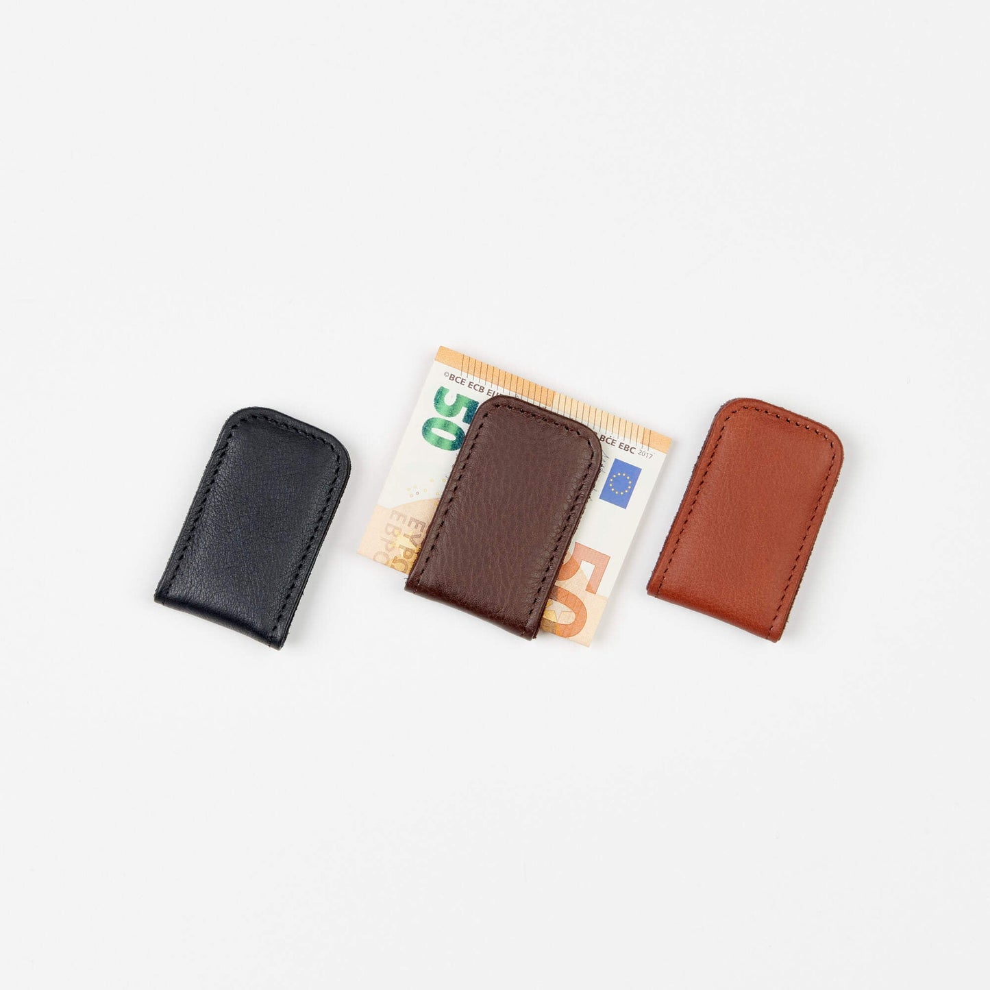 A group of leather wallets, including the Magnetic Money Clip, crafted with precision in Europe. Compact size for convenient carrying. Expert craftsmanship from Europe.