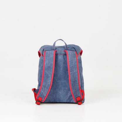 12L Canvas Backpack - Blue: A durable, water-repellent backpack designed for style and functionality. Spacious interior with laptop pocket and organized storage. Padded straps, bottom, and back for comfort. Handcrafted in Europe for premium quality.