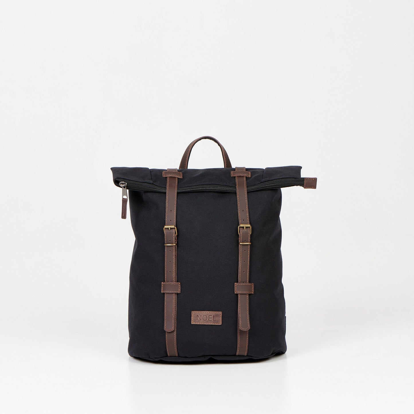 A black waterproof backpack with brown leather straps, perfect for urban adventures and daily commutes. Spacious 12L capacity, padded laptop compartment, and multiple pockets for organized storage. Handcrafted in Europe for quality and reliability.