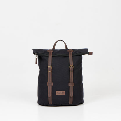 A black waterproof backpack with brown leather straps, perfect for urban adventures and daily commutes. Spacious 12L capacity, padded laptop compartment, and multiple pockets for organized storage. Handcrafted in Europe for quality and reliability.