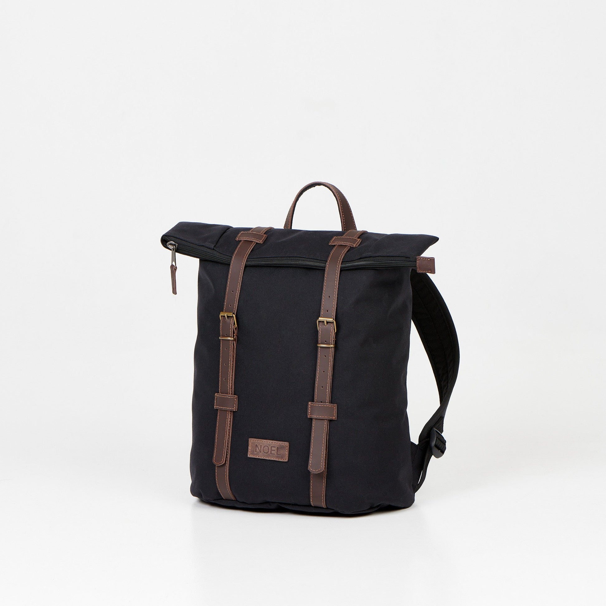 A black 12L Waterproof Backpack with brown leather straps and a lock closure, perfect for urban adventures and daily commutes.