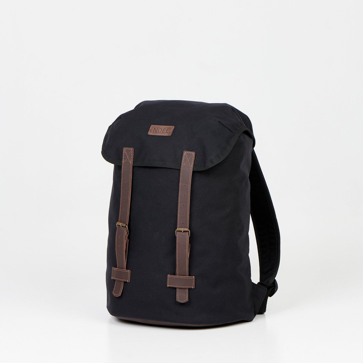 A durable 18L waterproof backpack in black with brown straps. Made of Cordura material, it features multiple pockets for easy organization, a padded laptop pocket, and a deeper pocket for a water bottle. Handcrafted in Europe with meticulous attention to detail. Perfect for daily adventures.