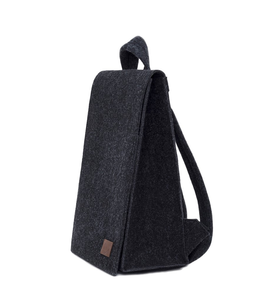 Backpack - Black: A minimalist, lightweight backpack with a brown patch. Features laptop pocket, adjustable straps, and magnetic snap closure. Eco-friendly and weatherproof. Ideal for a modern, stylish look.