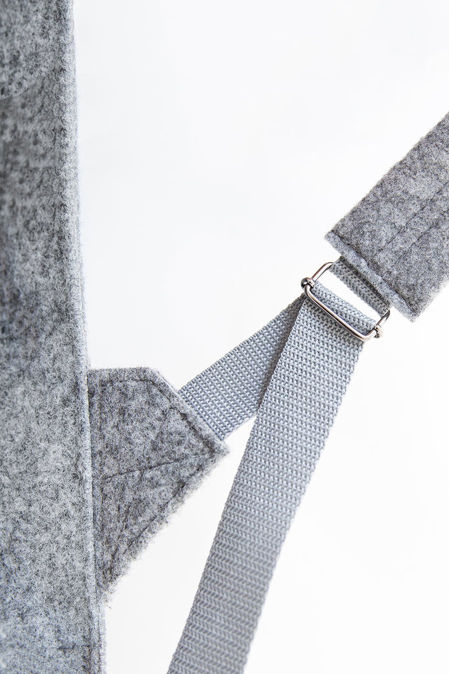 Backpack - Grey: A close-up of a striped fabric strap with a metal buckle, complementing a practical and stylish unisex backpack for modern lifestyles.