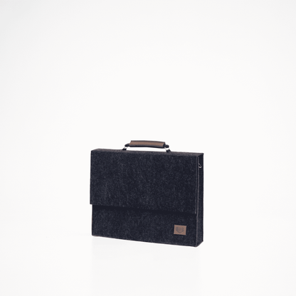 A sleek black briefcase with a separate sleeve for up to a 15" laptop. Crafted from eco-friendly material, this handmade European accessory offers reliable weatherproof protection for your belongings. Upgrade your work gear with this stylish and practical addition from Men In Style.