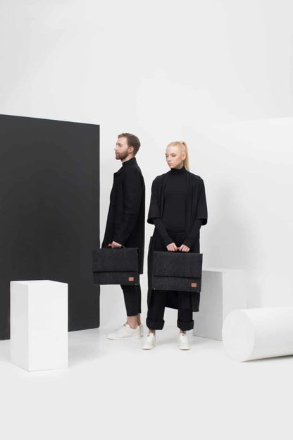 A man and woman holding black briefcases, showcasing the Briefcase with a separate sleeve for up to a 15" laptop - Black from Men In Style.