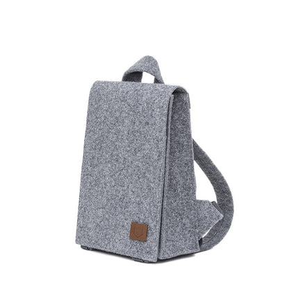 Mini Backpack - Grey: A sleek, compact backpack with a brown patch. Spacious enough for essentials and a small laptop. Functional details and durable material.