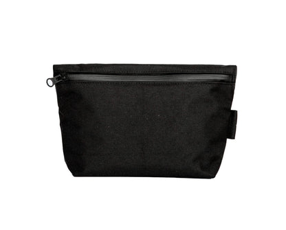 Toiletry bag with water-resistant black polyester canvas, YKK® zippers, and practical lightweight design for travel enthusiasts. Available in two sizes: Small (1.6L) and Medium (4.2L).