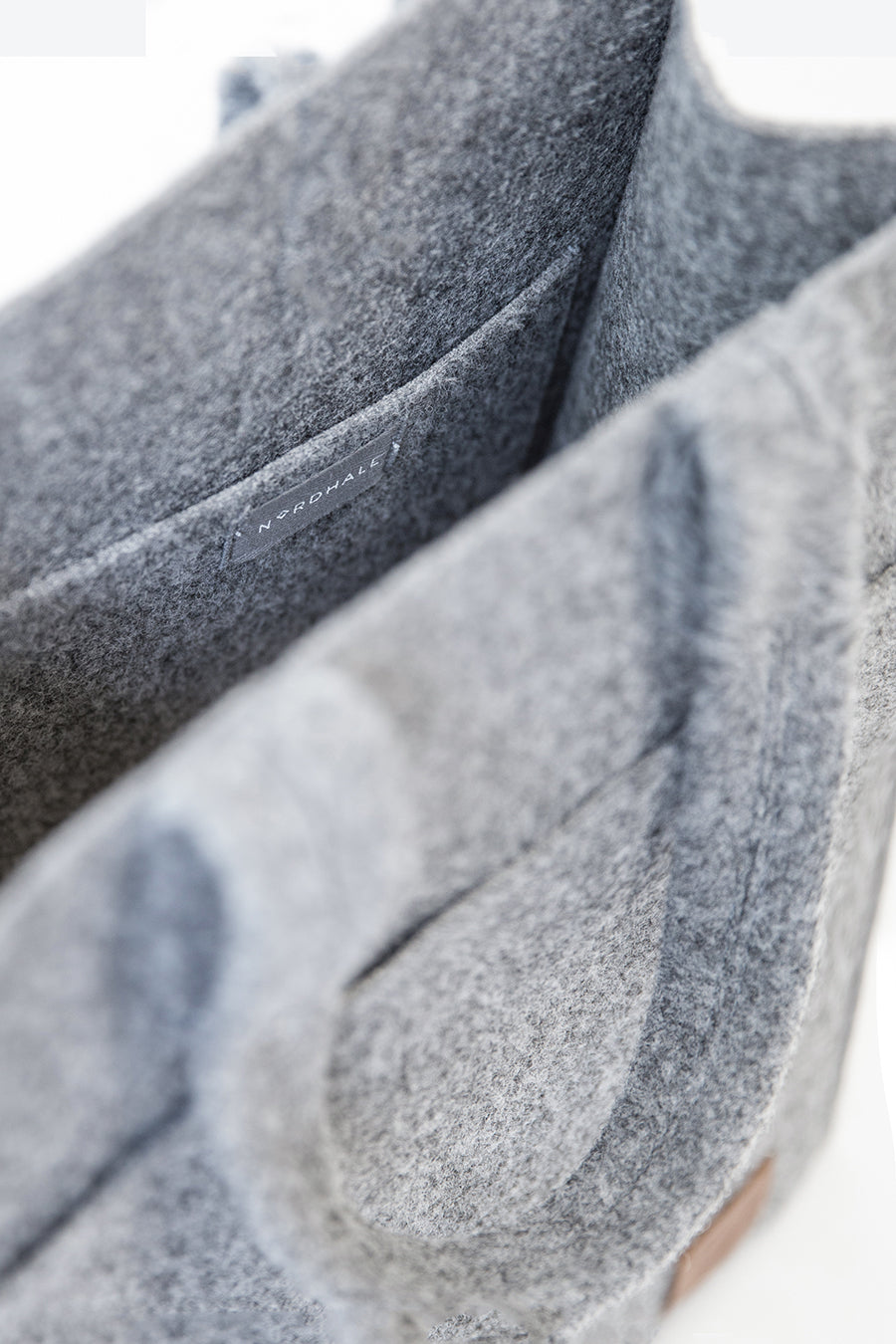 Tote Bag - Grey: A close-up of a sustainable, weatherproof bag made from recycled PET felt. Features a spacious interior with a laptop pocket.