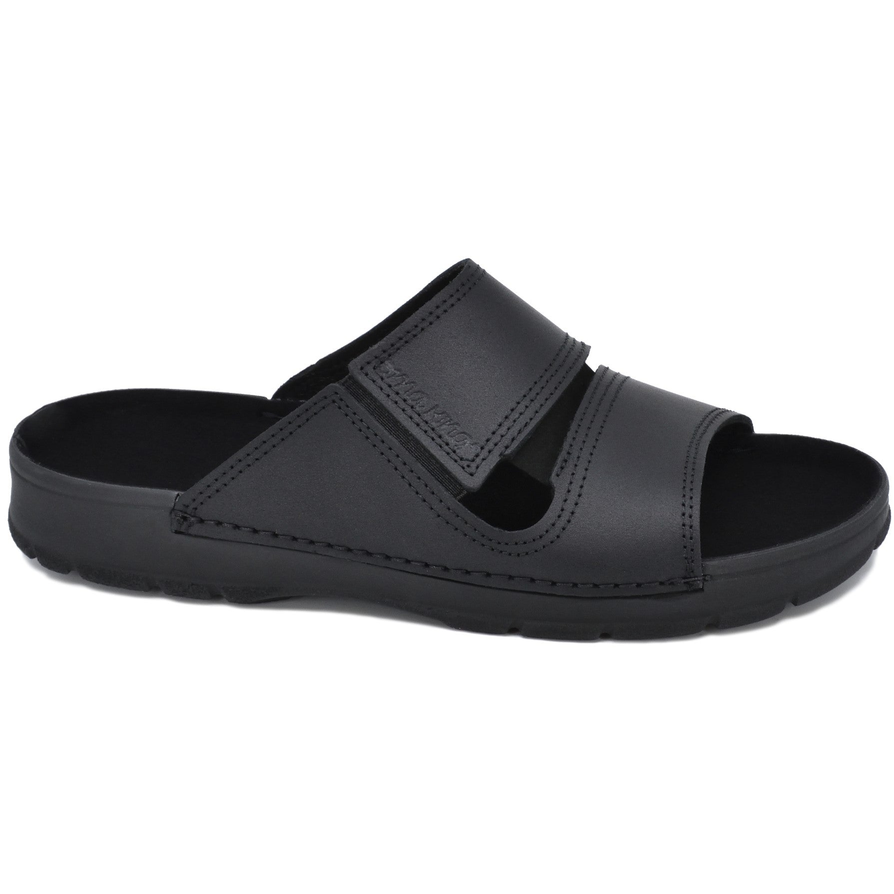 Slip-On Leather Sandals - Black: A black sandal with a velcro strap, crafted from natural leather. Features a soft microfiber lining and elastic, durable outsole. Versatile for various settings.