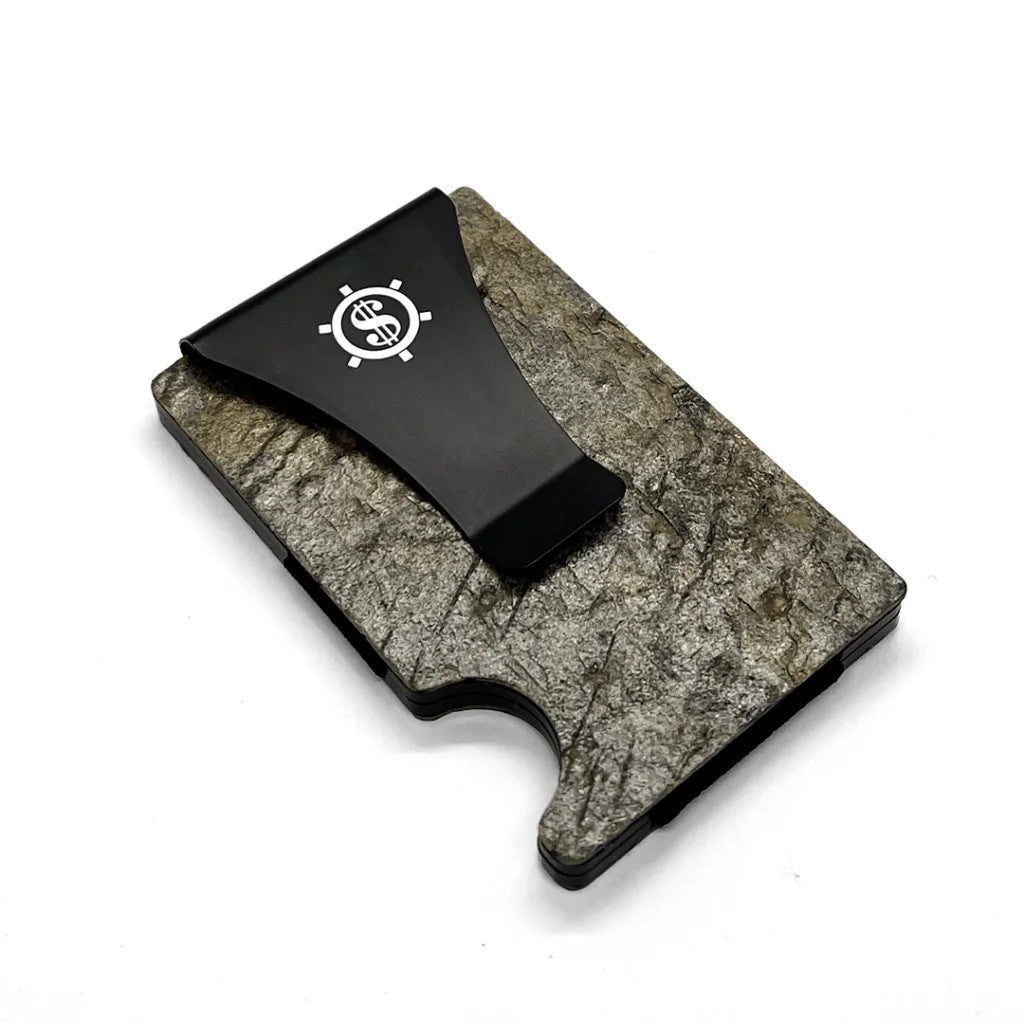 A black plastic money clip on a slate stone card holder with RFID blocking technology.